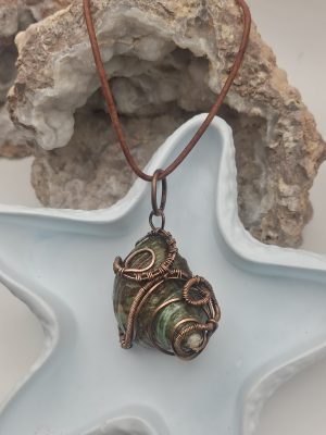 Turbinidae shell wrapped in oxidized copper wire